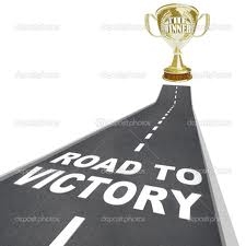Trophy on a road with the words 'Road to Victory' on it.