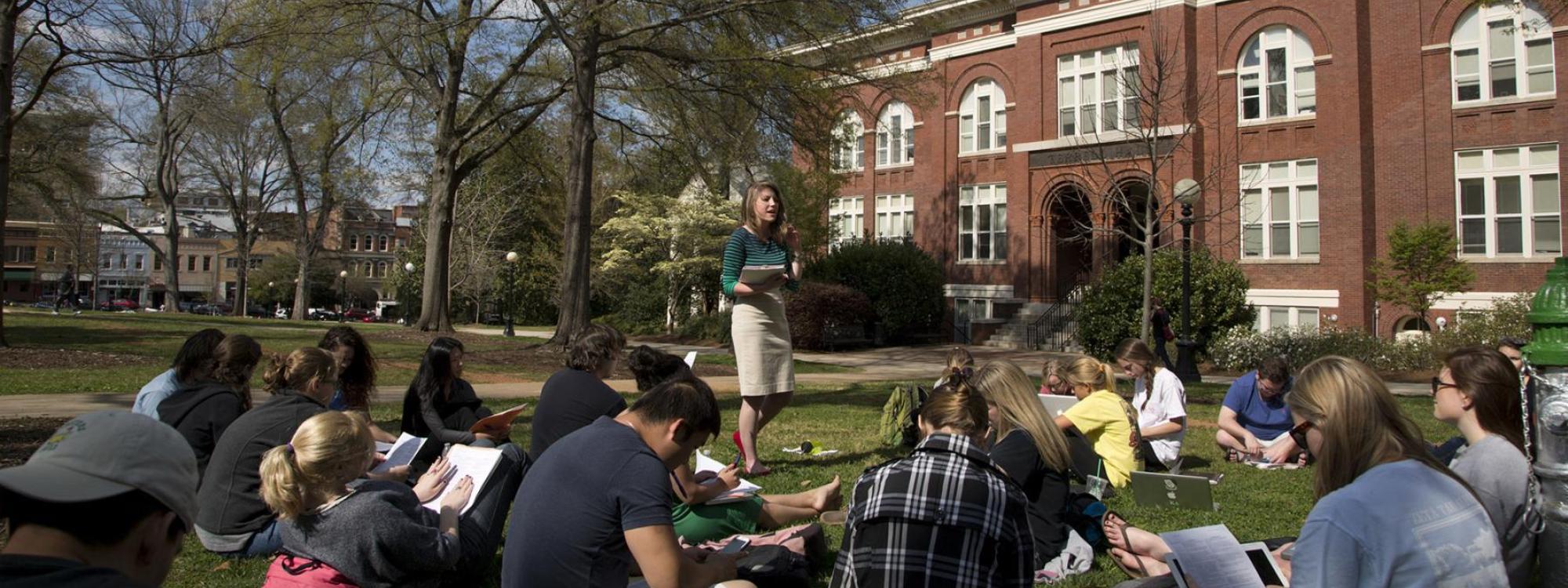 Communication students studying on the lawn on campus at the University of Georgia